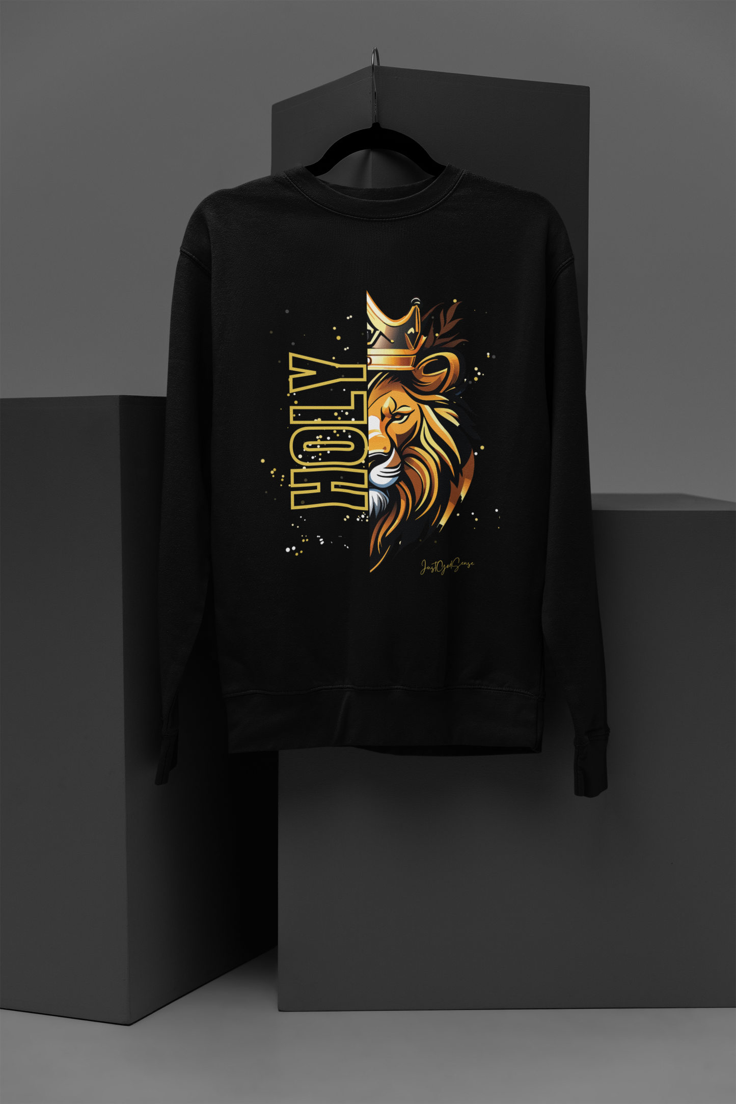 Black sweatshirt with a gold and orange graphic design on a dark background