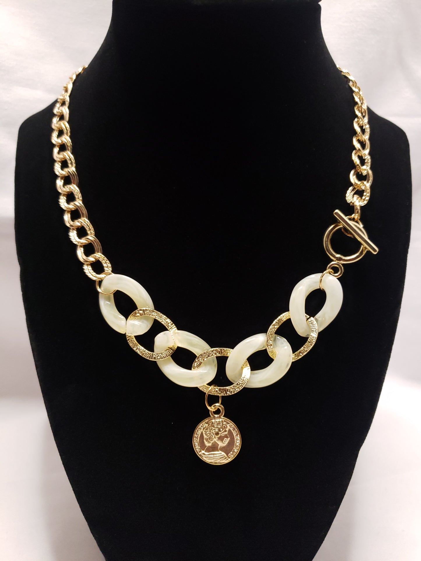 Creme acrylic gold plated chain link necklace with coin pendant